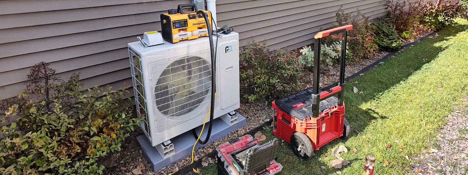 Ductless Direct technician repairing a mini-split outdoor unit at a Chicagoland home